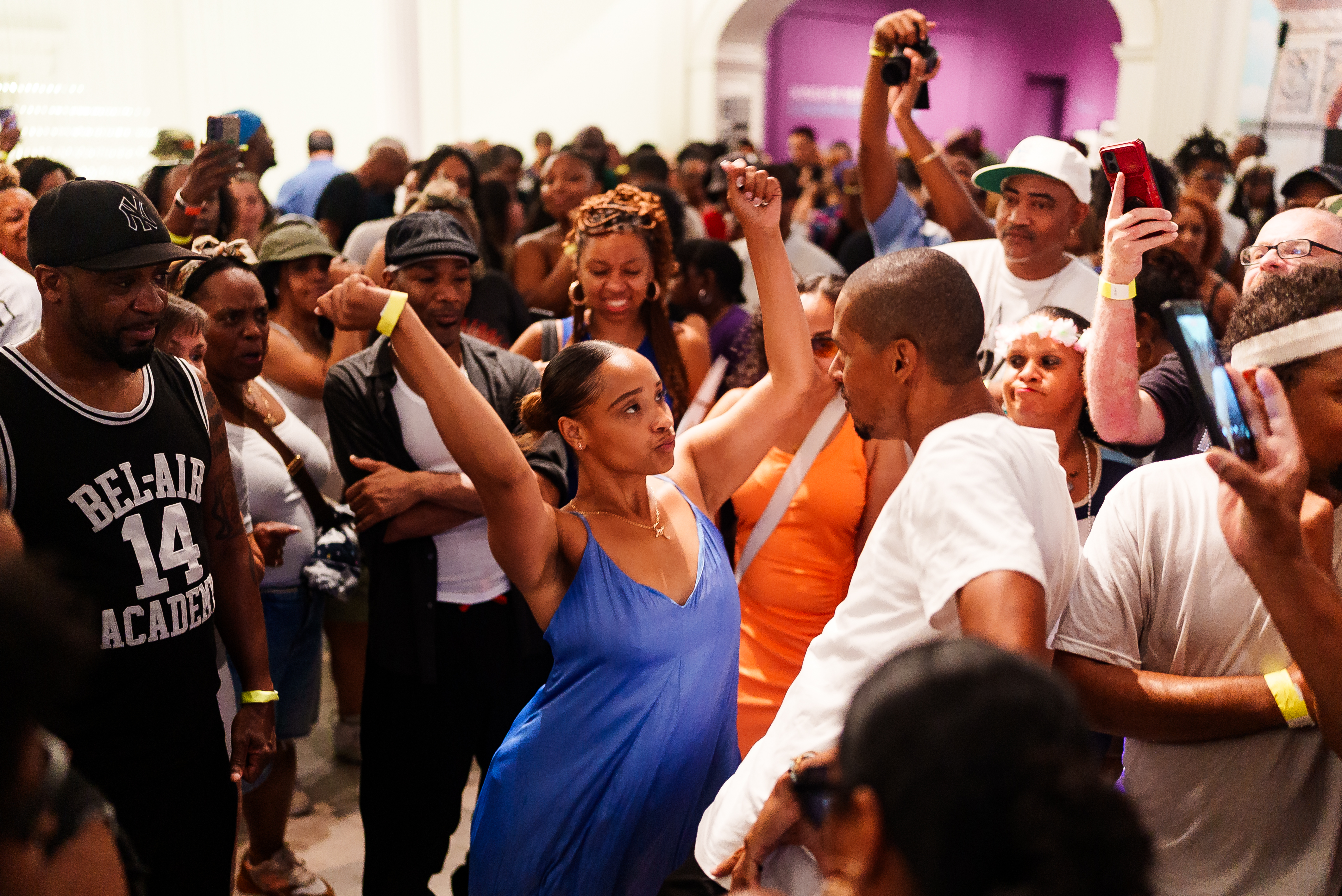 Woman and man dancing in a crowd of people